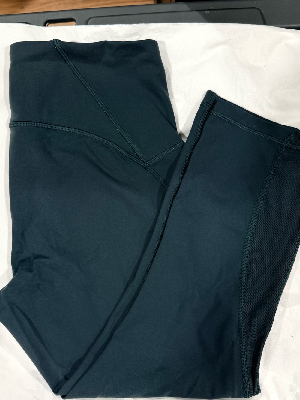 Lululemon Wunder Under Crop leggings in a classic dark olive green color. These